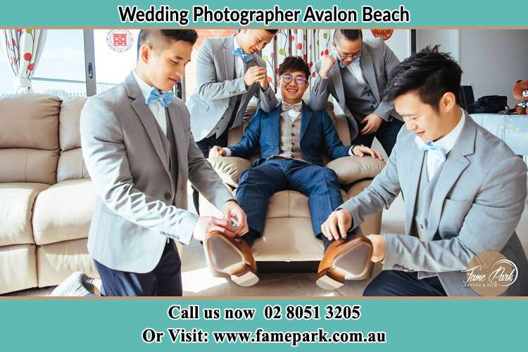 Photo of the Groom helping by the groomsmen getting ready Avalon Beach NSW 2107