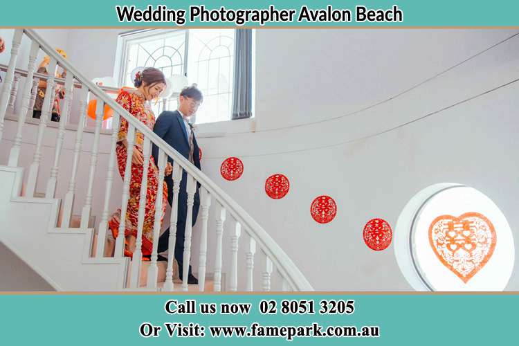 Photo of the Bride and the Groom going down the stair Avalon Beach NSW 2107