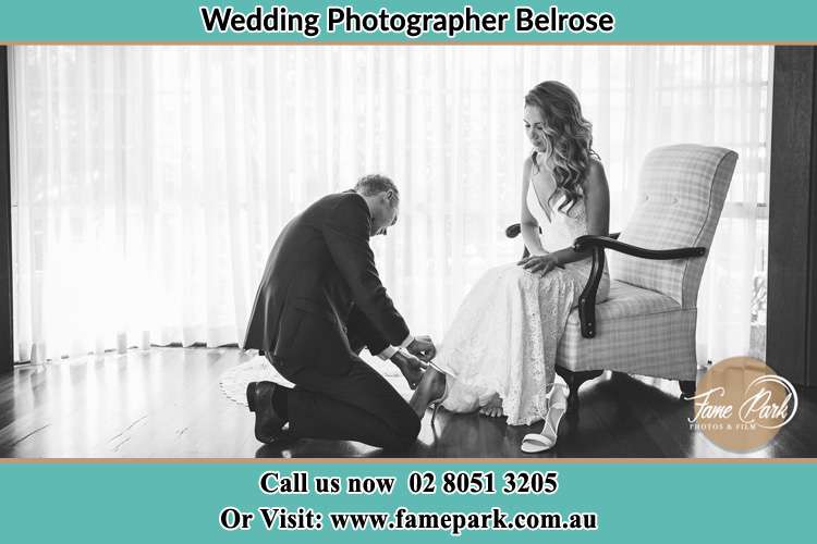 The Bride is being helped by the Groom trying to put on her shoes Belrose NSW 2085