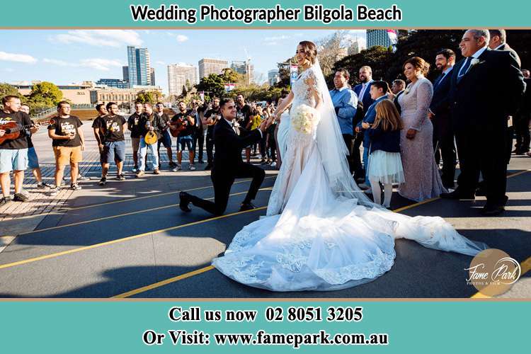 Groom Kneeling down infront of the Bride Bilgola Beach NSW 2107