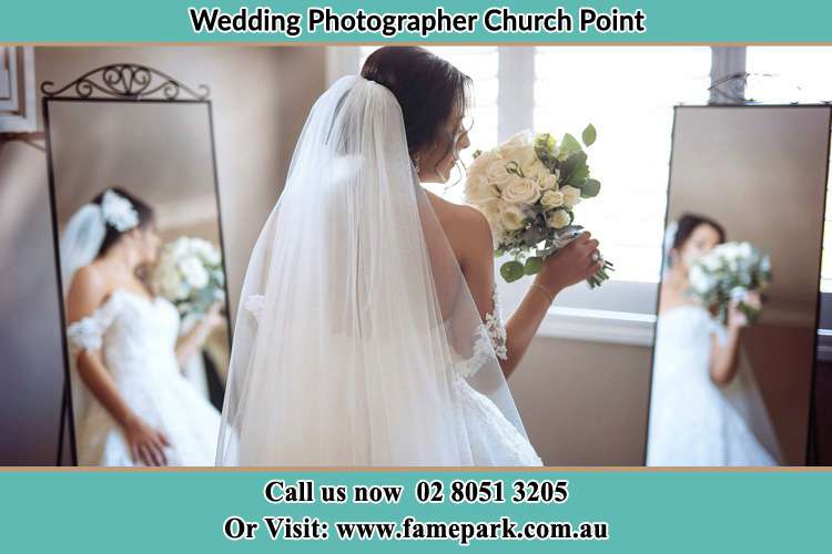 Photo of the Bride holding flower in front of the mirrors Church Point NSW 2105