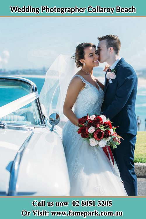 Photo of the Bride kiss by the Groom besides the bridal car Collaroy Beach NSW 2097