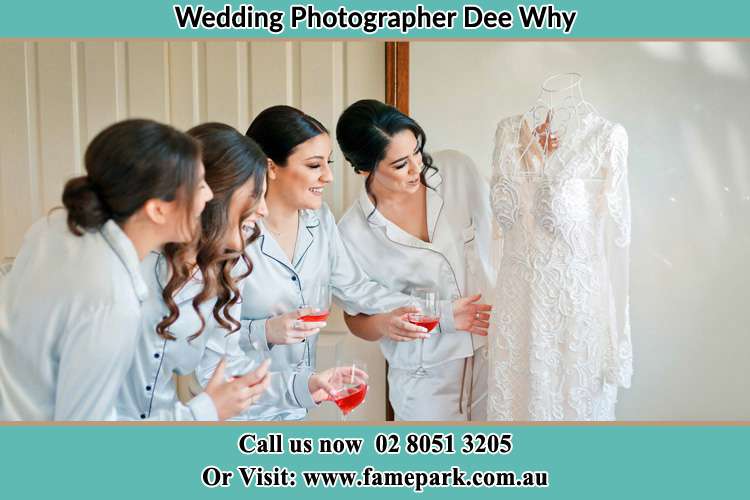 Photo of the Bride and the bridesmaids checking the bridal gown Dee Why NSW 2099