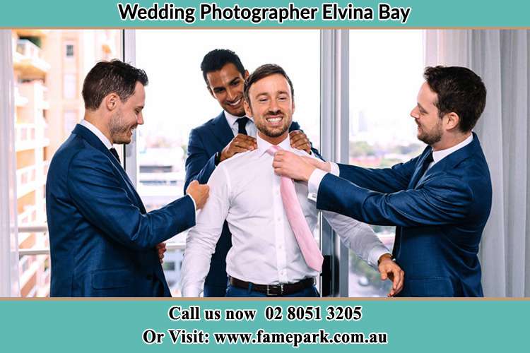 Photo of the Groom helping by the groomsmen getting ready Elvina Bay NSW 2105