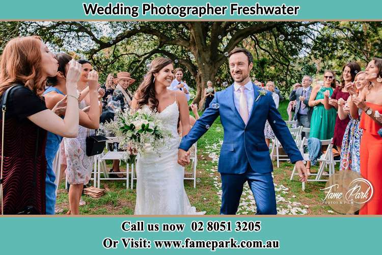 Photo of the Bride and the Groom showering bubbles by the visitors Freshwater NSW 2096