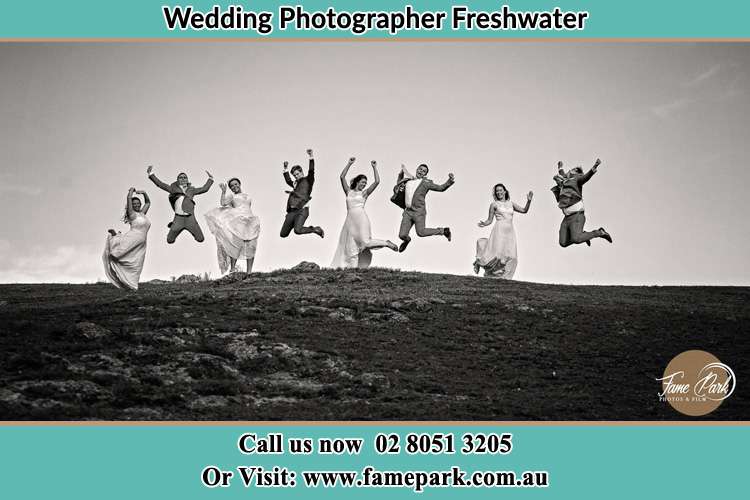 Jump shot photo of the Bride and the Groom with the entourage Freshwater NSW 2096