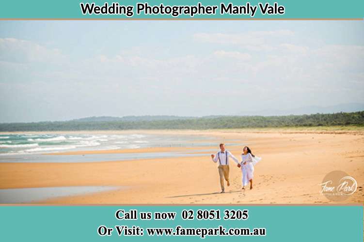 Photo of the Groom and the Bride walking near the sea shore Manly Vale NSW 2093