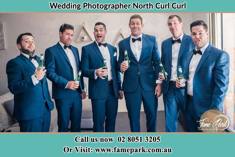 The groom and his groomsmen striking a wacky pose in front of the camera North Curl Curl NSW 2099