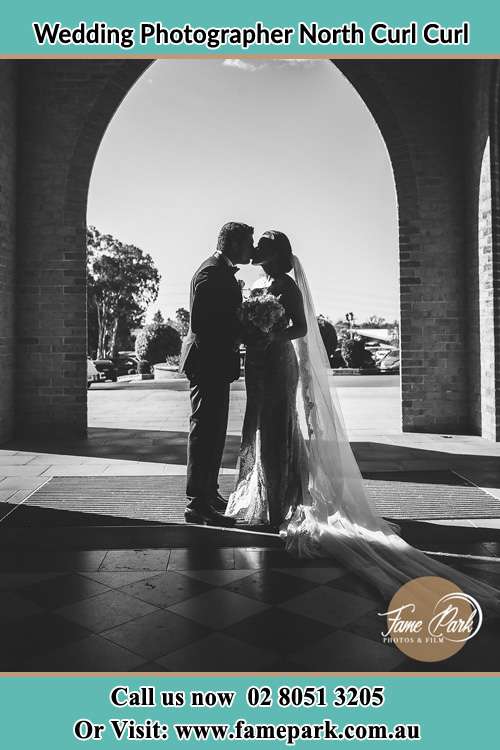 Photo of the Groom and the Bride kissing at the front of the church North Curl Curl NSW 2099