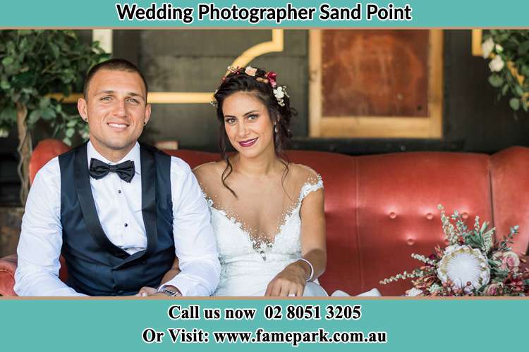 The Groom and the Bride sitting and smiling on the camera Sandy Point NSW 2172