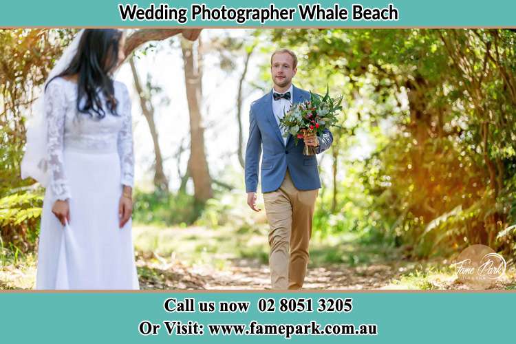 Photo of the Groom bringing flower to the Bride Whale Beach NSW 2107